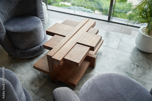 Unique wooden table in a modern style in the living room.
