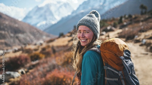 AI generated illustration of a young backpacker woman smiling while hiking in the Himalayas © Wirestock