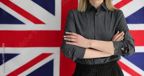 Wallpaper Mural Woman crosses arms confidently in front of British flag. Getting British citizenship and learning English Torontodigital.ca