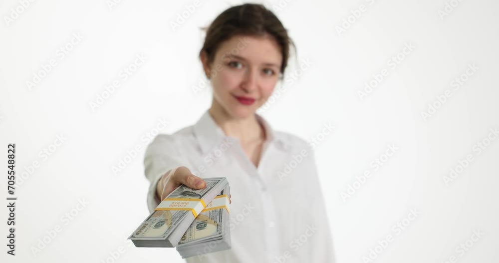 Smiling woman gives stack of dollar bills to client. Offering a bribe or financial investment Smiling woman gives stack of dollar bills to client. Offering a bribe or financial investment