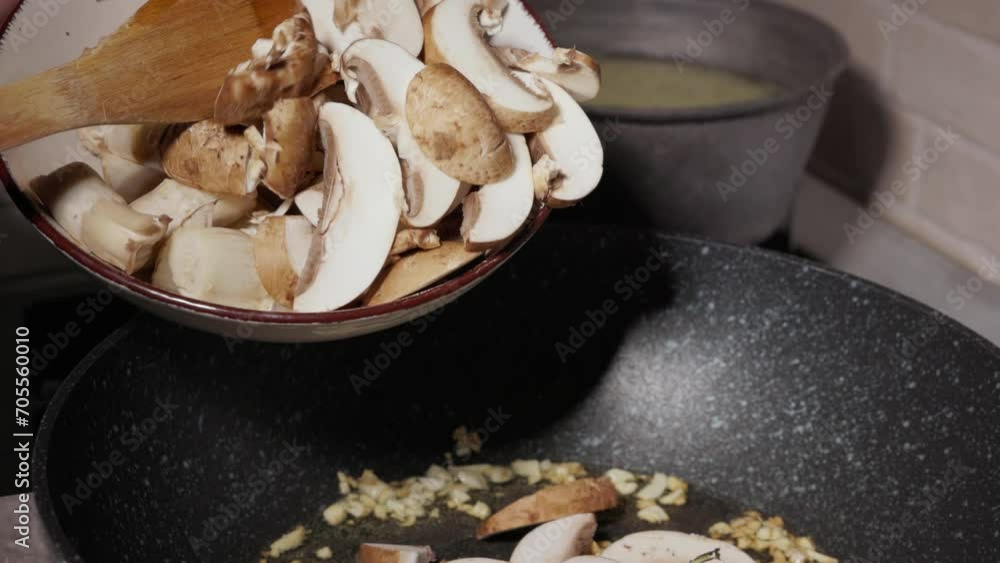 Pouring Sliced And Chopped Mushrooms Into Frying Pan - Close Up Pouring Sliced And Chopped Mushrooms Into Frying Pan - Close Up