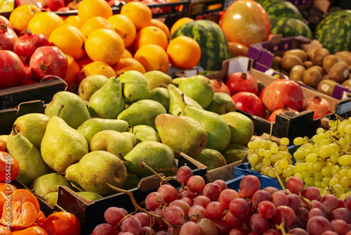 Many different fresh ripe fruits on counter at market