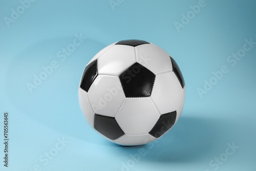 One soccer ball on light blue background. Sports equipment