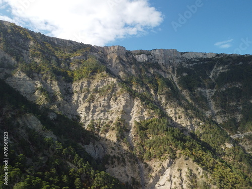 Aerial panoramic view of forest on rocky mountain slope - Ai Petri, Yalta, Crimea. Abstract aerial nature forest and mountains. Weather and Climate Change. Vacation, travel and holiday concept © panophotograph