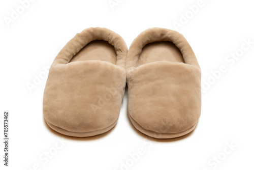 cozy composition. homemade fluffy warm beige slippers stand on a white background