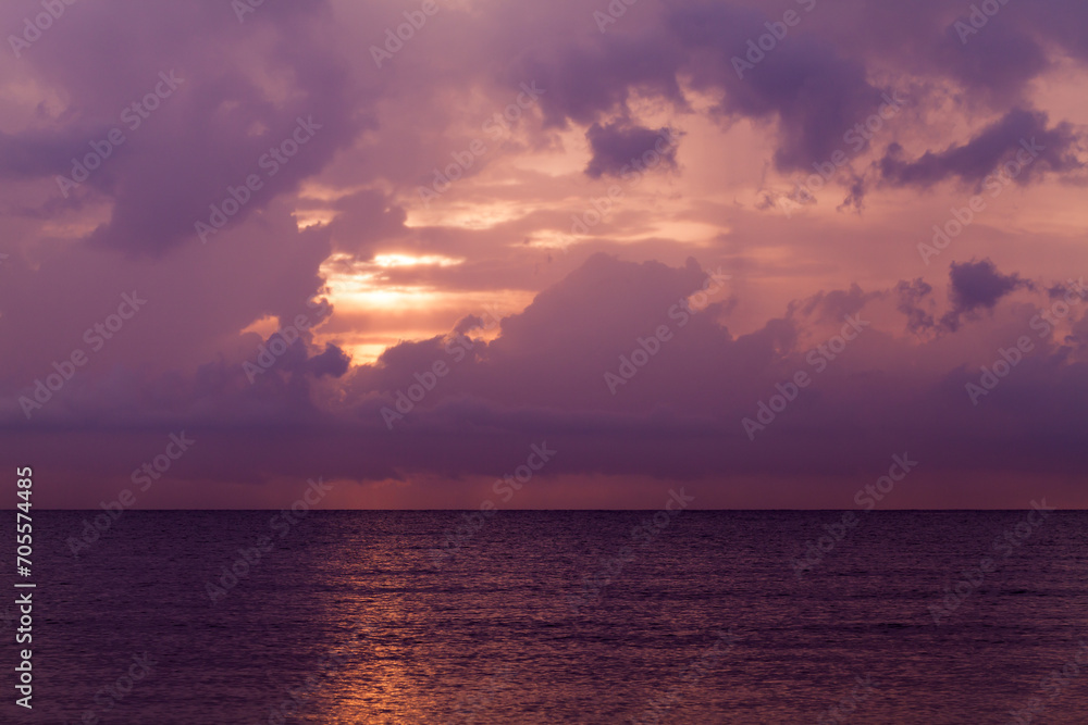 Colorful tropical sky. Landscape photo with dark sunset clouds over the ocean