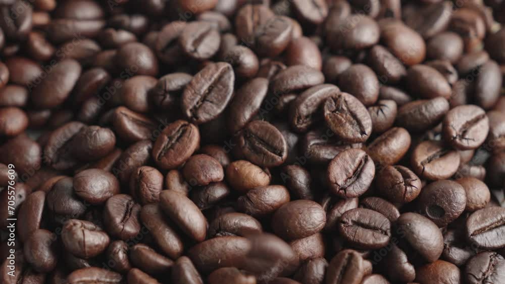 Roasted coffee beans dropping and piling up. Macro close up Roasted coffee beans dropping and piling up. Macro close up
