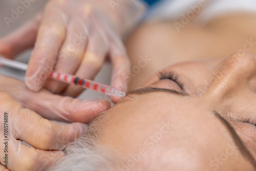 Woman having beauty procedures at beauty clinic and receiving beauty injections
