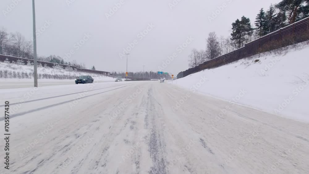 The car skillfully negotiates difficult winter conditions on the highway, smoothly navigating snowy terrain at high speed. The car skillfully negotiates difficult winter conditions on the highway, smoothly navigating snowy terrain at high speed.