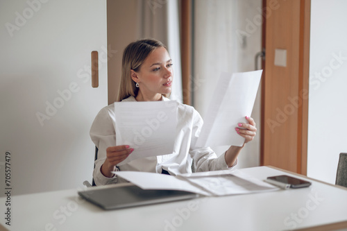 Cute blonde young wo an working with documents
