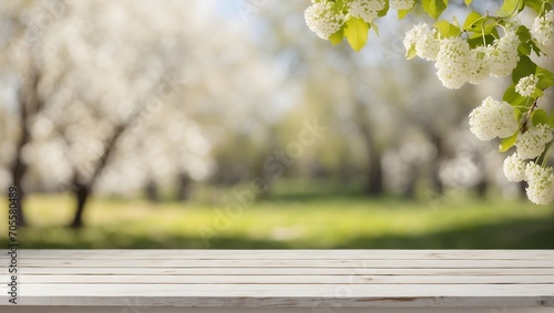 empty white wooden linden table with blurred spring background photo