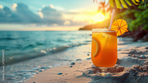 Glass of orange juice on tropical beach with palm leaves and sea background
