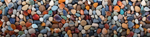 long narrow panoramic view background multicolored sea polished stones, rolled pebbles on the seashore texture gems