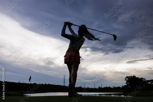 silhouette of professional asian woman golfer practice in golf course,