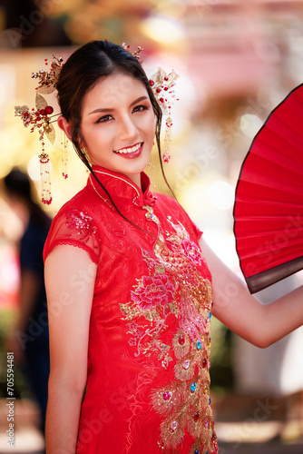 Chinese new year , Portrait of young asian woman with traditional Chinese  red drese in temple , photo