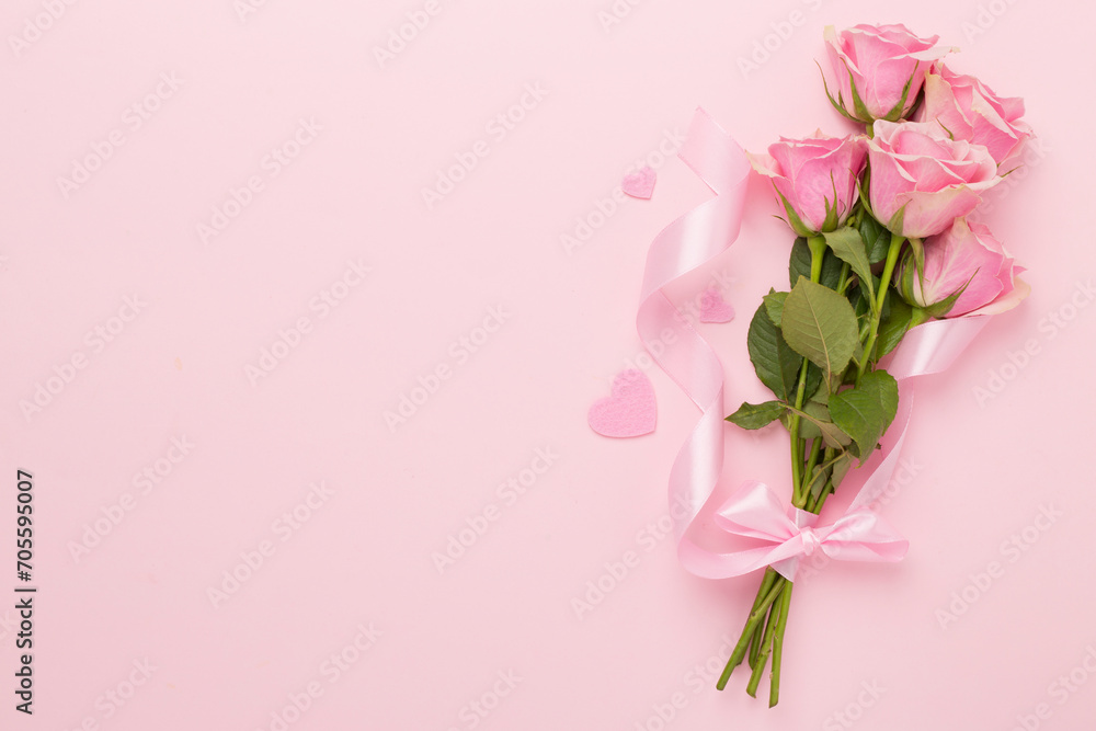 Pink roses with hearts on color background, top view. Valentines day concept Pink roses with hearts on color background, top view. Valentines day concept