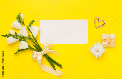 Open gift box, with fresia flower color background, top view