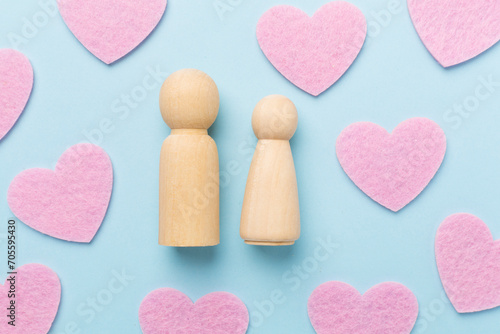 Wooden couple in love on color background, top view. Creative valentine's day composition