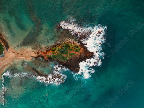 Scenic aerial drone view of Parrot rock - small island along the Mirissa Beach in Sri Lanka. Braking waves top view aerial photo from flying drone. Traveling and exotic countries concept. High quality © Buyanskyy Production