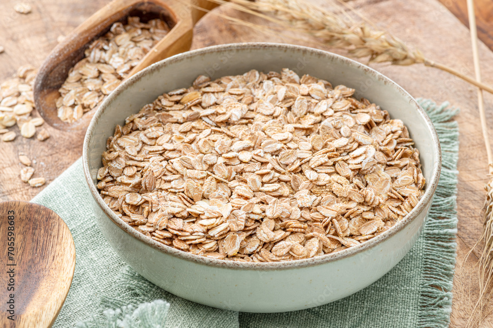 Bowl of wheat flakes on wooden table. Top view. Rural concept. Bowl of wheat flakes on wooden table. Top view. Rural concept.