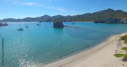 Overlooking a protected bay of sailing yachts anchorage near a white sand beach surrounded by small mountains of the coast of San Juanico, Mexico, Baja California Sur photo