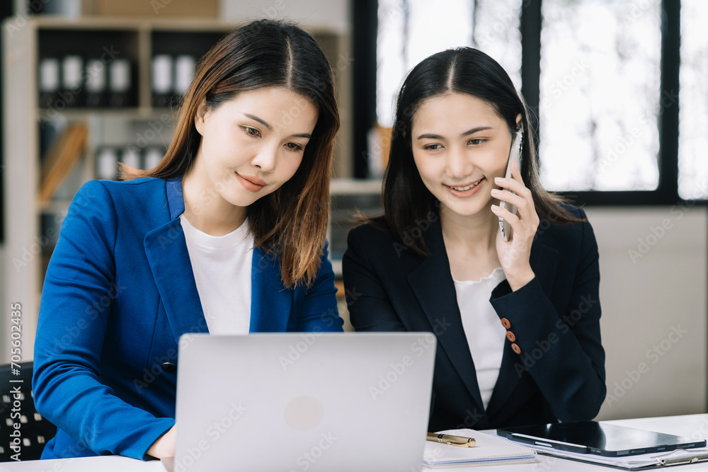 Business women or accountant working on laptop computer with business document, graph diagram and calculator on office table in office. Business women or accountant working on laptop computer with business document, graph diagram and calculator on office table in office.