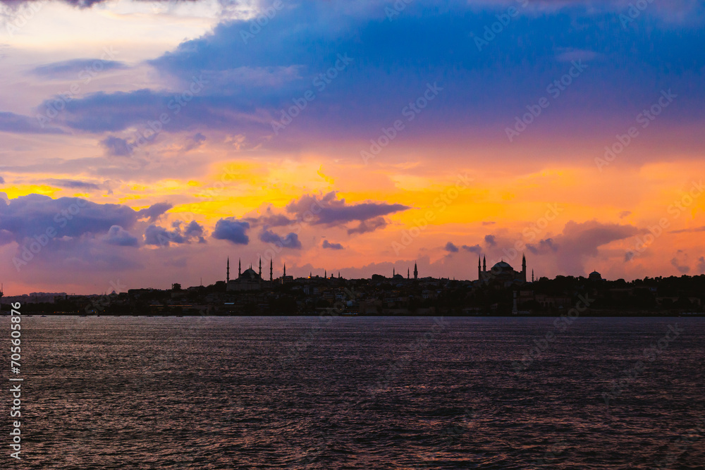 Silhouette of Istanbul at sunset with dramatic clouds.