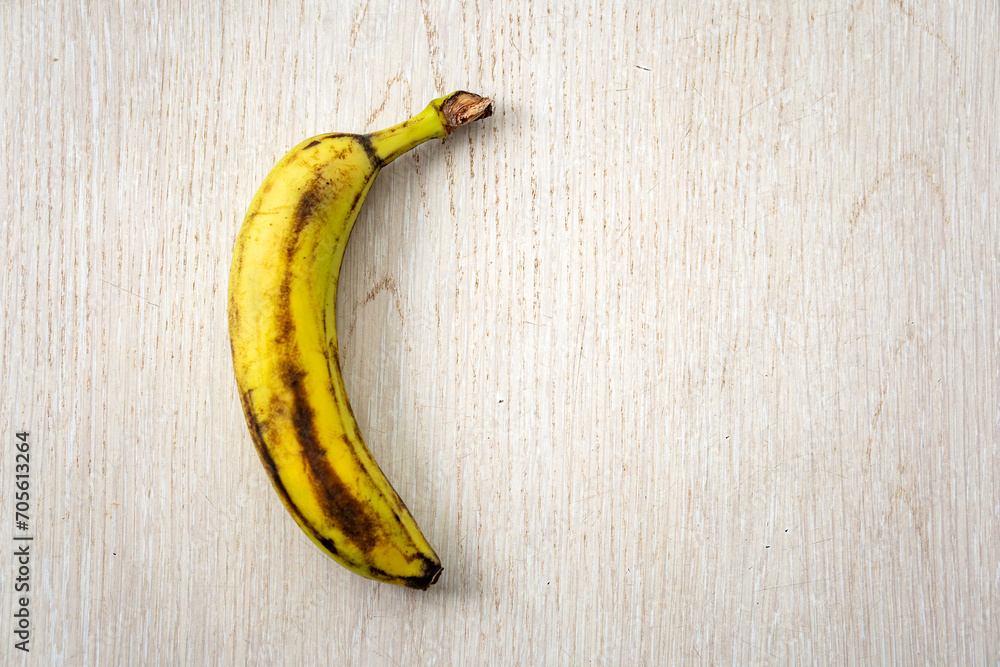 Over ripe banana isolated on wooden background. Over ripe banana isolated on wooden background.