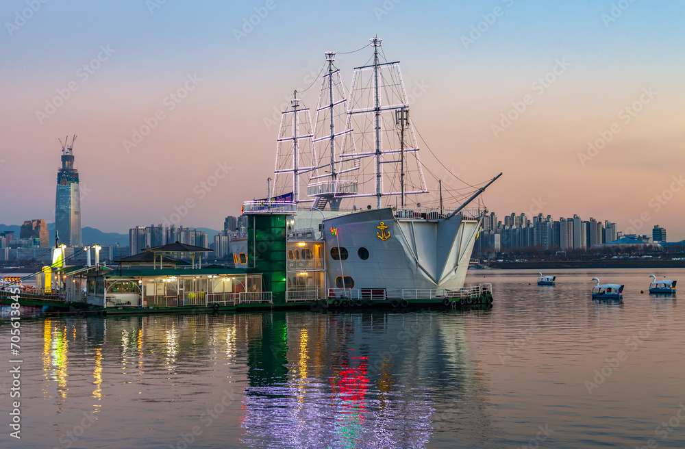 Sunset view of Han River Park in Seoul, South Korea, where cruise ship lights are shining