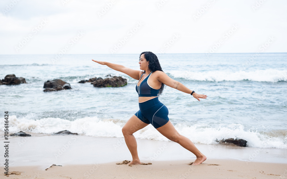 Fitness woman, athlete, doing balance exercises on the beach sand. Fitness woman, athlete, doing balance exercises on the beach sand.