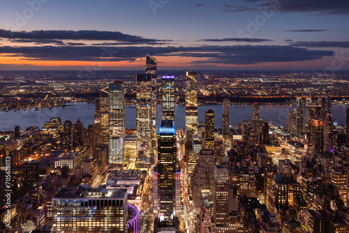 Aerial view of Midtown West Manhattan toward Hudson River with Hudson Yards skyscrapers at twilight. Chelsea and Hell's Kitchen neighborhood of New York City