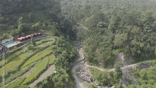 In the serene heart of Uttarakhand's mountains, a rustic hut stands as a humble abode, surrounded by the breathtaking beauty of nature's embrace. High quality footage photo