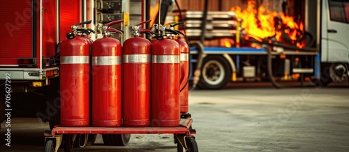 Mobile fire extinguisher on trolley wheels used in fire stations.
