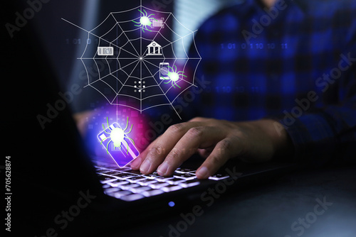 Cyber security concept with spider is stolen credit card information from user on laptop computer and collect in spider web represent spyware looking to steal banking information photo