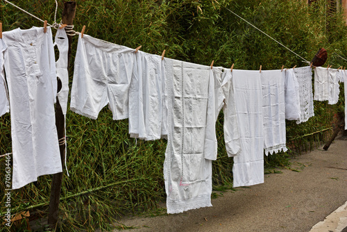 Old underwear and sheets hanging to dry. Laundry hung out, clothesline with ancient linen