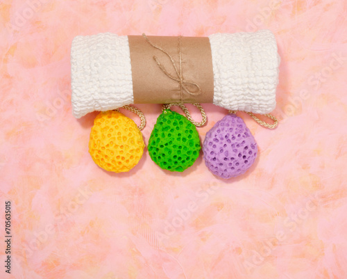 A white shower towel and colorful washcloths. Copy space for text  top view.