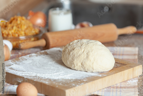 dough piece board in front of rolling pin....