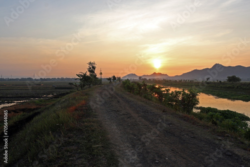 Beautiful sunrise in the countryside. Scenic view of a river at dawn.