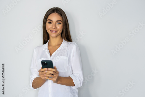 Portrait of a businesswoman using mobile phone isolated over white background
