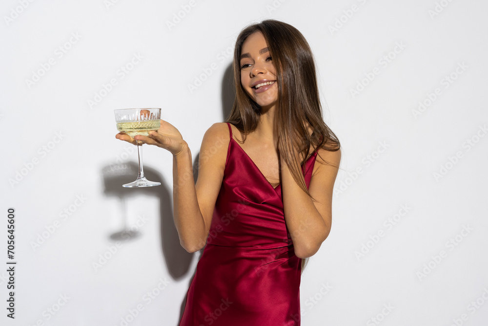 Portrait, champagne and toast with a woman in red isolated on white background at an event, party or gala. Portrait, champagne and toast with a woman in red isolated on white background at an event, party or gala.