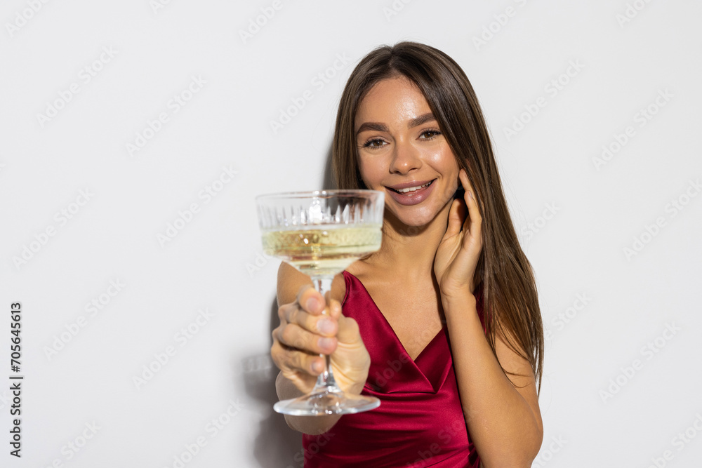 Portrait, champagne and toast with a woman in red isolated on white background at an event, party or gala. Portrait, champagne and toast with a woman in red isolated on white background at an event, party or gala.