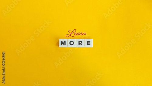 Learn More Banner. Block Letter Tiles and Cursive Text on Flat Yellow Orange Background. Minimalist Aesthetics.
