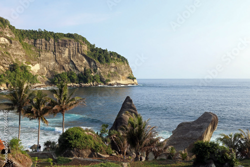 View of the idyllic Indonesian coast of Java Island with majestic mountains and tranquil ocean waters.