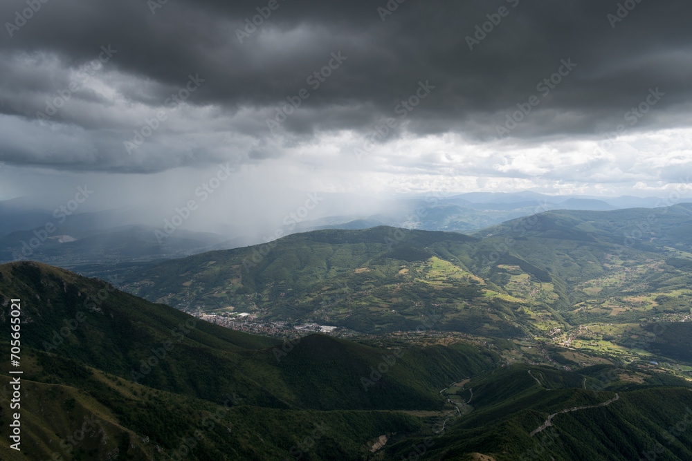 Downpour over mountains and gloomy clouds, view from Vlasic mountain