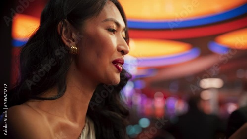 Modern Casino: Gorgeous Asian Woman Laughing and Having Fun on a Night Out with Friends. Portrait of a Glamorous and Gracious Lady on a Fancy Party Having Good Time, Naturally. Blurred Party Envent photo