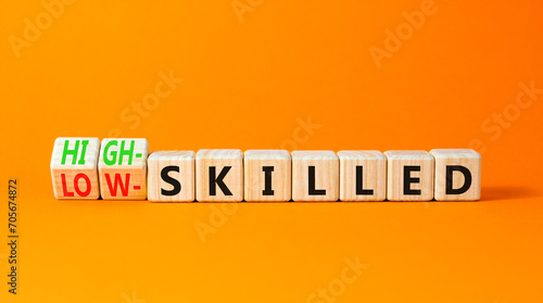 High or low skilled symbol. Concept words High-skilled or Low-skilled on beautiful wooden blocks. Beautiful orange table orange background. Business high or low skilled concept. Copy space.