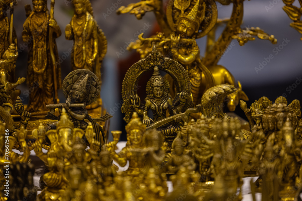 Brass metal art, Handmade goddess saraswati souvenir made with brass with blur background. Selective focus.
