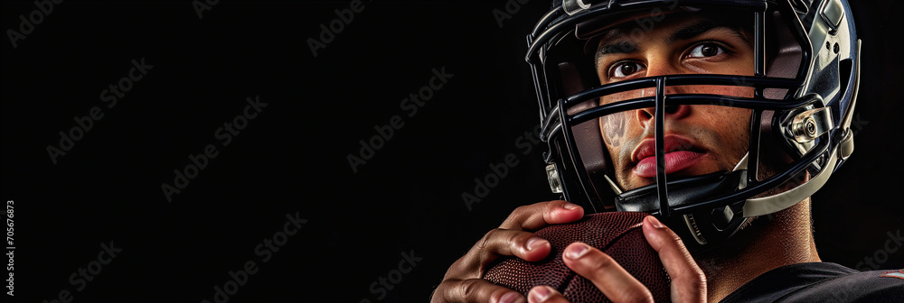 American football player in helmet holding ball, standing closeup on black background American football player in helmet holding ball, standing closeup on black background