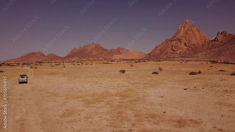Drone tracking of a car driving in the desert with mountains ahead - Toyota 4x4 Drone tracking of a car driving in the desert with mountains ahead - Toyota 4x4
