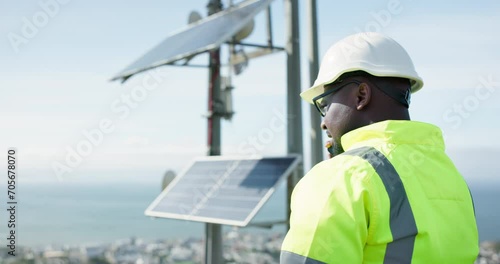 Solar panel, contractor or black man on a phone call for communication, advice or building project. Outdoor, energy or builder in conversation for architecture, planning or construction inspection photo